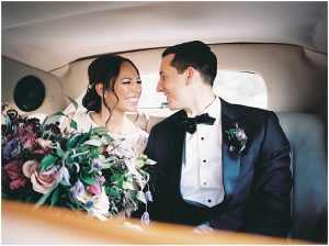 bride and groom in classic car